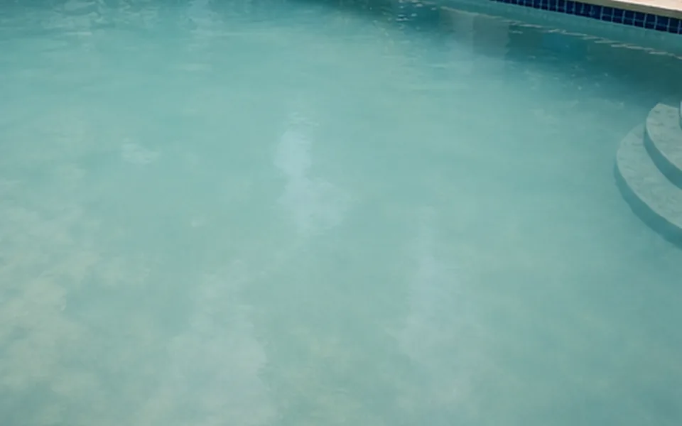 Cloudy blue pool water needing chemical balancing